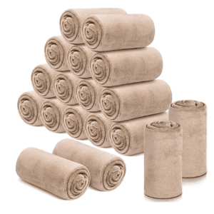 A pile of rolled up towels sitting next to each other.